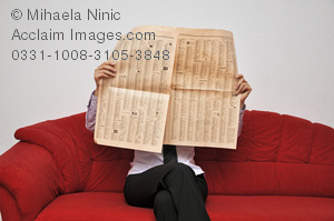 Businesswoman reading newspaper